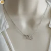 Collier pour femme en acier avec ses cœurs entrelacés - Création Bijoutissimo.