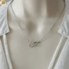 Collier pour femme en acier avec ses cœurs entrelacés - Création Bijoutissimo.